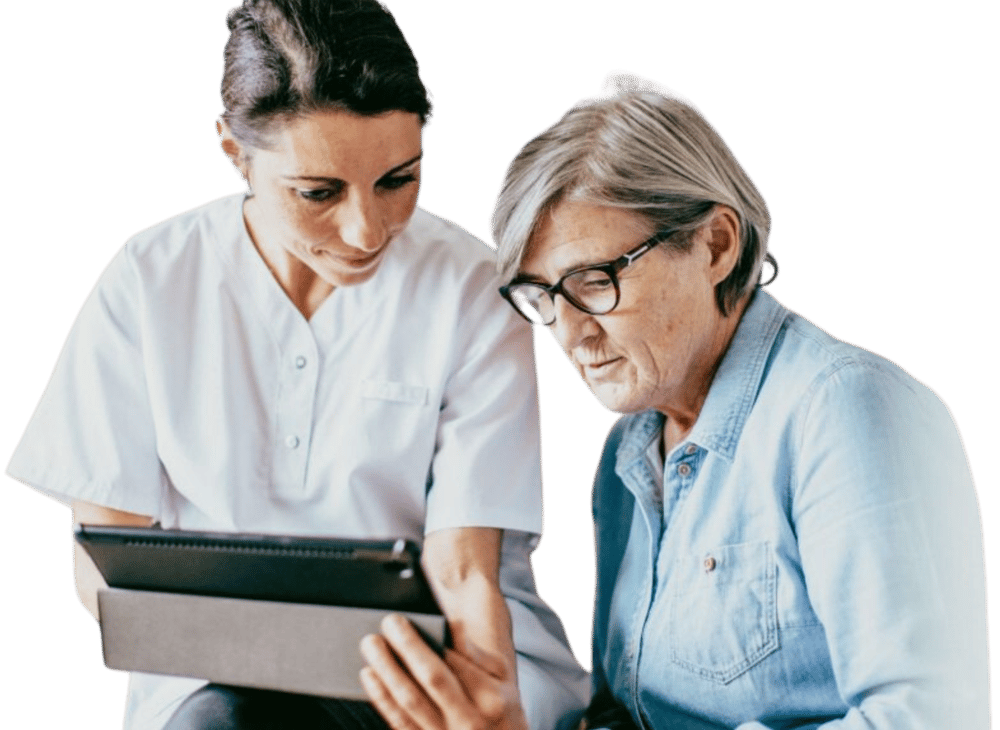 Clinician showing an elderly patient information on a tablet Clinician showing an elderly patient information on a tablet