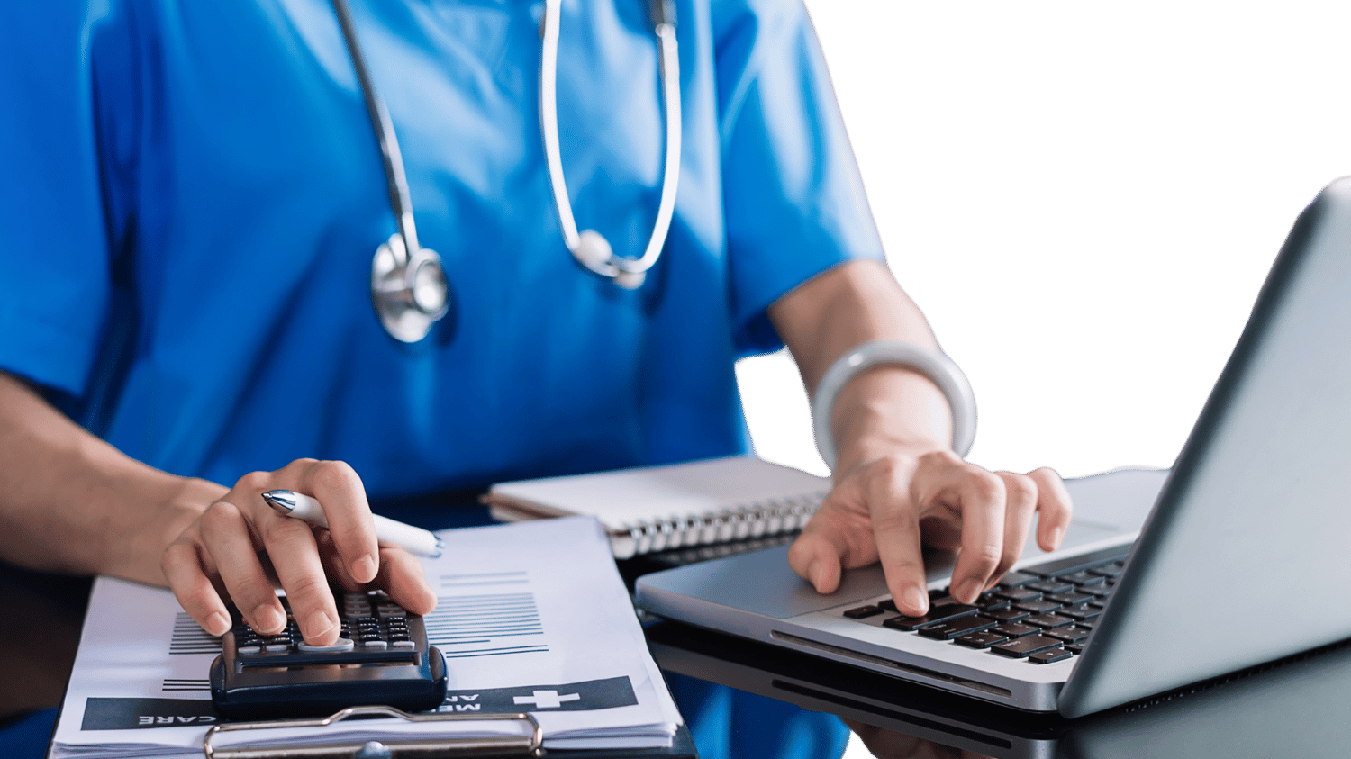 Clinician typing on computer while using calculator Clinician typing on computer while using calculator